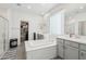 Spacious bathroom with a tub, walk-in shower, and double sink vanity at 14325 W Faye Way, Surprise, AZ 85387