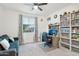 Comfortable bedroom with carpet, ceiling fan, a gray couch, and a window at 14325 W Faye Way, Surprise, AZ 85387