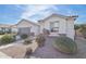 Charming single-story home featuring desert landscaping, a gray garage door, and picturesque front yard at 14325 W Faye Way, Surprise, AZ 85387