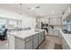 Modern kitchen featuring an island, gray cabinets, stainless appliances, and open to the dining area at 14325 W Faye Way, Surprise, AZ 85387