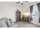 Cozy living room featuring a comfortable gray couch, and a built-in bookshelf for storage at 14325 W Faye Way, Surprise, AZ 85387