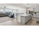 Open living room with a gray leather couch, view of the dining area and modern kitchen at 14325 W Faye Way, Surprise, AZ 85387