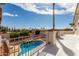 Balcony view overlooking the pool area with mature trees, a wrought iron fence, and mountain views at 14401 N 29Th St, Phoenix, AZ 85032