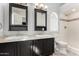 Bathroom with dual sinks, dark wood vanities, and subway tile shower at 14401 N 29Th St, Phoenix, AZ 85032