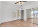 Light-filled bedroom with mirrored closet doors, ceiling fan, and hardwood floors at 14401 N 29Th St, Phoenix, AZ 85032