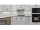 Close-up of a kitchen with white cabinets, stainless steel appliances, granite countertops, and hexagon tile backsplash at 14401 N 29Th St, Phoenix, AZ 85032