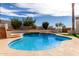 Backyard pool with a rock waterfall feature surrounded by mature landscaping and lush greenery at 14401 N 29Th St, Phoenix, AZ 85032