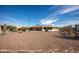 View of the backyard landscaping, desert foliage and exterior of home with enclosed patio at 15602 N Nicklaus Ln, Sun City, AZ 85351