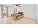 Clean and bright bedroom featuring wood-look tile flooring, ceiling fan, and nice window view at 15602 N Nicklaus Ln, Sun City, AZ 85351