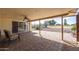 View of the covered patio with brick pavers, ceiling fan, and views of the community golf course at 15602 N Nicklaus Ln, Sun City, AZ 85351