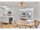 Charming dining area with white cabinets and a view into the adjacent living room at 15602 N Nicklaus Ln, Sun City, AZ 85351