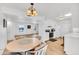 Open-concept dining room showcasing white cabinetry and an adjacent living space at 15602 N Nicklaus Ln, Sun City, AZ 85351