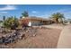 Well-maintained home featuring desert landscaping, a two-car garage, and a welcoming front entrance at 15602 N Nicklaus Ln, Sun City, AZ 85351