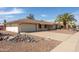 Inviting home with mature landscaping, a two-car garage, and a covered front porch at 15602 N Nicklaus Ln, Sun City, AZ 85351