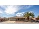 Single-story home featuring a two-car garage, desert landscaping, and a welcoming entrance at 15602 N Nicklaus Ln, Sun City, AZ 85351