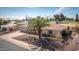 Inviting home with desert landscape, two-car garage, and well-maintained front yard at 15602 N Nicklaus Ln, Sun City, AZ 85351