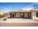 View of the patio with brick pavers, furniture, and lush vegetation at 15602 N Nicklaus Ln, Sun City, AZ 85351