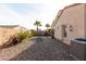 Desert backyard with rock landscaping, palm trees and comfortable outdoor seating at 17632 W Voltaire St, Surprise, AZ 85388