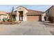 Inviting single-story home featuring a tiled roof, attached garage, and desert landscaping at 17632 W Voltaire St, Surprise, AZ 85388