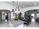 Open-concept kitchen with a central island, sleek pendant lighting, and views into adjacent living spaces creating flow at 17632 W Voltaire St, Surprise, AZ 85388