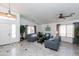 Inviting living room with neutral tones, stylish furniture, plenty of natural light, and tiled floors for easy maintenance at 17632 W Voltaire St, Surprise, AZ 85388