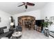 Open living space showcasing tile floors, a ceiling fan, and an archway that gives views into the eat-in kitchen at 17632 W Voltaire St, Surprise, AZ 85388