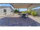 This outdoor gazebo features a stone dining table with seating, a paved patio, and views of the artificial turf at 1840 N Brighton Cir, Mesa, AZ 85207