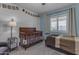 Cozy bedroom featuring a crib, accent wall, and neutral colors at 1840 N Brighton Cir, Mesa, AZ 85207