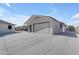 A detached garage with a roll-up door and concrete driveway at 1840 N Brighton Cir, Mesa, AZ 85207