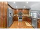 Traditional kitchen featuring stainless steel appliances, wood cabinets, and hardwood floors at 1840 N Brighton Cir, Mesa, AZ 85207