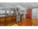 Traditional kitchen island featuring stainless steel appliances, wood cabinets, and hardwood floors at 1840 N Brighton Cir, Mesa, AZ 85207