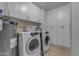 Functional laundry room featuring modern appliances and ample storage at 1840 N Brighton Cir, Mesa, AZ 85207