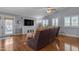 Cozy living room with hardwood floors, white shutters, ceiling fan, and patio doors at 1840 N Brighton Cir, Mesa, AZ 85207