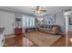 Cozy living room featuring a plush sofa, ceiling fan, and natural light from the window at 1840 N Brighton Cir, Mesa, AZ 85207