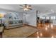 Open-concept living room with hardwood floors, a ceiling fan, and a view into the dining area at 1840 N Brighton Cir, Mesa, AZ 85207