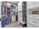 Organized walk-in closet with custom shelving, hanging rods, and ample storage space at 1840 N Brighton Cir, Mesa, AZ 85207