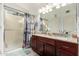 This bathroom features a shower with glass door, dark wood cabinets, and granite countertops at 1847 E Milky Way, Gilbert, AZ 85295