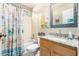 This bathroom features a shower and tub combo, light cabinets, a granite countertop, and natural light at 1847 E Milky Way, Gilbert, AZ 85295