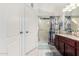 This bathroom features a shower with glass door, white cabinets, and granite countertops at 1847 E Milky Way, Gilbert, AZ 85295