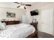 This bedroom features a ceiling fan, TV, dark wood dresser, and a queen size bed at 1847 E Milky Way, Gilbert, AZ 85295