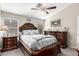 This bedroom features a ceiling fan, dark wood dressers, and a queen size bed at 1847 E Milky Way, Gilbert, AZ 85295