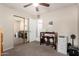 This bedroom features a ceiling fan, light walls, and a desk with chairs for working from home at 1847 E Milky Way, Gilbert, AZ 85295