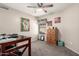 This bedroom features a ceiling fan, light walls, a wood dresser, and natural light at 1847 E Milky Way, Gilbert, AZ 85295