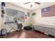 This bedroom features a ceiling fan, a window with natural light, and hardwood floors at 1847 E Milky Way, Gilbert, AZ 85295