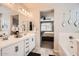 Elegant bathroom with dual sinks, white countertops, and a view into the connected bedroom at 18625 W Williams Rd, Surprise, AZ 85387