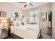 Charming bedroom featuring a plush bed, mirrored nightstand, and serene decor at 18625 W Williams Rd, Surprise, AZ 85387