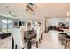 Dining area featuring a modern light fixture and wood flooring with adjacent rooms at 18625 W Williams Rd, Surprise, AZ 85387