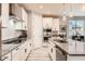 Modern kitchen featuring stainless steel appliances, granite countertops, white cabinetry and eat in bar at 18625 W Williams Rd, Surprise, AZ 85387