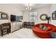 Cozy living room featuring unique round sofa, modern decor, and comfortable seating arrangement at 18625 W Williams Rd, Surprise, AZ 85387