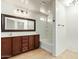 Bathroom with a large mirror, vanity, and a bathtub with tiled walls at 18637 W Fulton St, Goodyear, AZ 85338